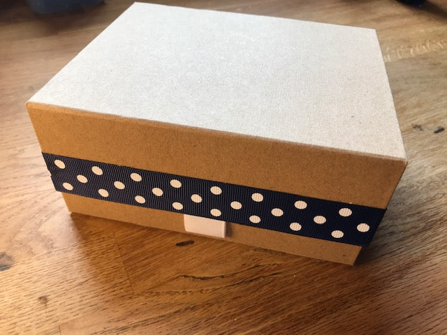 Luxury kraft gift box with a spot ribbon. Lid clips shut with a magnet